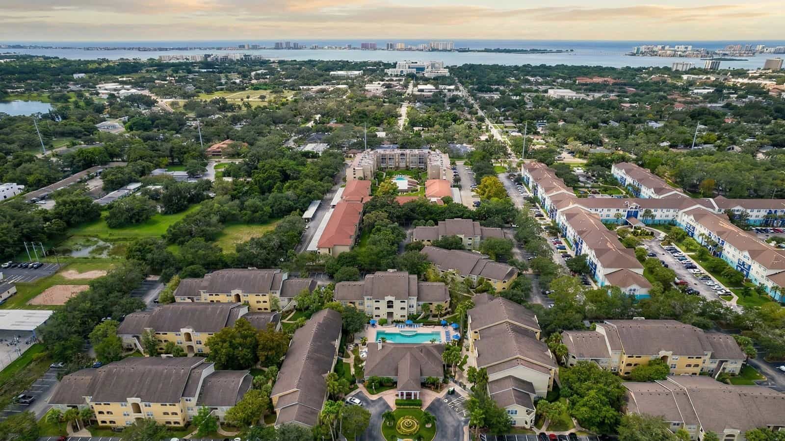 Aerial view of Avalon at Clearwater community with pool and ocean in the distance.