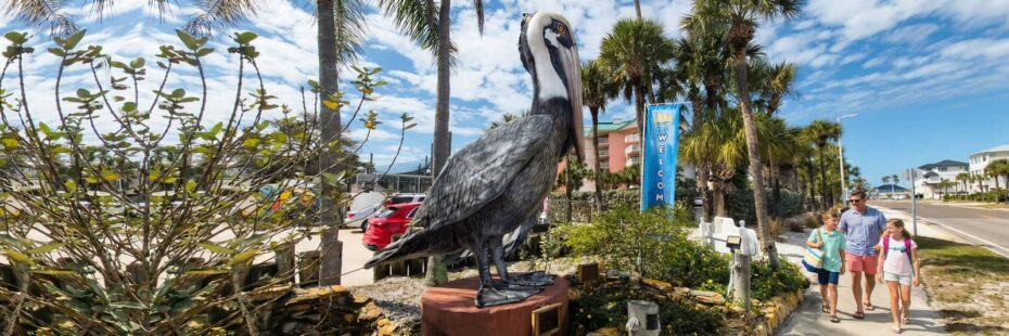 Families walking past the Seaside Seabird Sanctuary entrance in Indian Shores